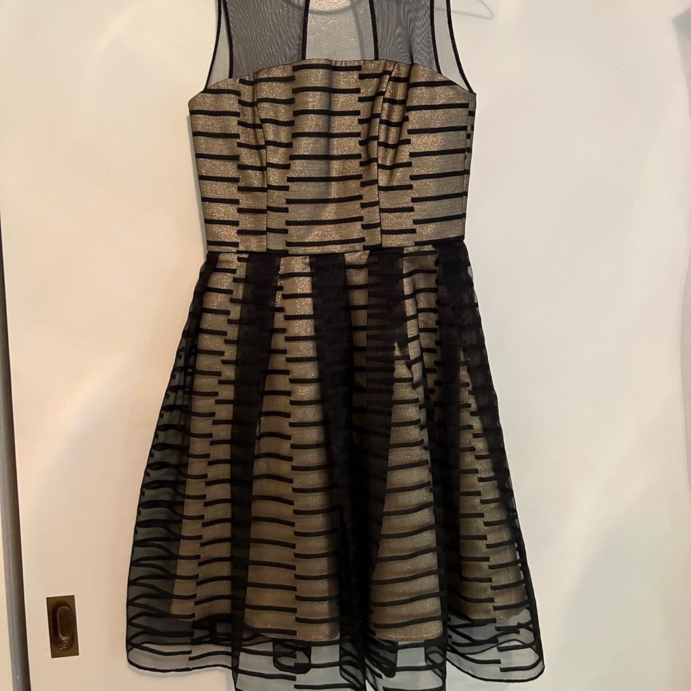 Guess Marciano gold glitter cocktail dress with black mesh overlay.